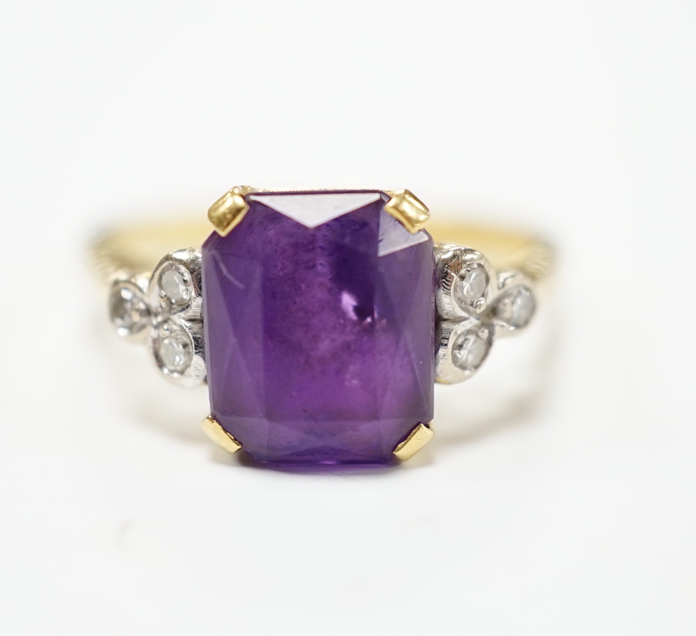 An 18ct and single stone emerald cut amethyst set ring with diamond set shoulders, size M, gross weight 4.5 grams.